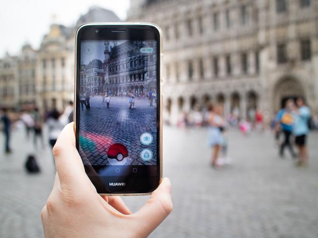 A gamer hunts for Pokemon at the Grand Place - Grote Market square in Brussels. Picture: AFP