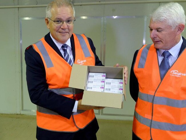 Prime Minister Scott Morrison with a palette of COVID vaccine at CSL Melbourne. Picture: NCA NewsWire / Andrew Henshaw