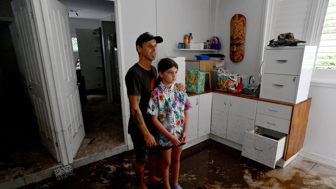 Bluewater residents Anthony Waugh, with daughter Nyah, 9, at the ground floor of their Forrestry Road home inundated by a fast rising Bluewater Creek. Picture: Evan Morgan