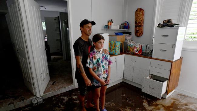 \Bluewater residents Anthony Waugh, with daughter Nyah, 9, at the ground floor of their Forrestry Road home inundated by a fast rising Bluewater Creek. Picture: Evan Morgan