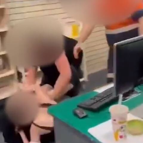 Two teens fight inside the library in front of staff.