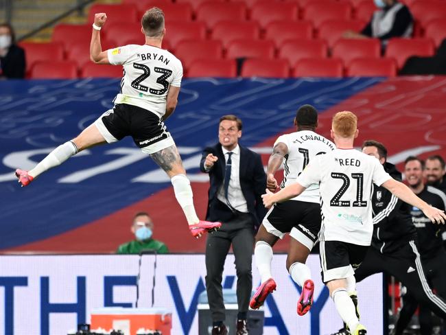 LONDON, ENGLAND - AUGUST 04: Joe Bryan of Fulham celebrates after scoring his sides first goal during the Sky Bet Championship Play Off Final match between Brentford and Fulham at Wembley Stadium on August 04, 2020 in London, England. Football Stadiums around Europe remain empty due to the Coronavirus Pandemic as Government social distancing laws prohibit fans inside venues resulting in all fixtures being played behind closed doors. (Photo by Shaun Botterill/Getty Images)