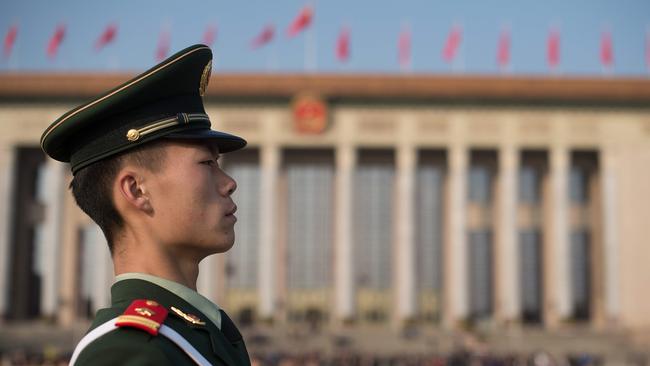 A paramilitary policeman stands guard at Tiananmen square during the closing session of the 19th Communist Party Congress in Beijing.