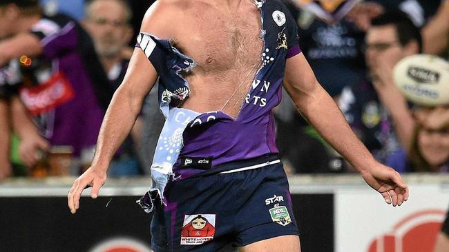 GRAPPLE: Melbourne Storm&#39;s Cameron Smith with a shredded jersey. No doubt he&#39;d deny it coming from any sort of grappling in the ruck. Picture: JULIAN SMITH-AAP