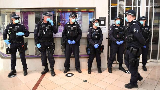 Police patrol through a shopping centre after an anti-lockdown protest in the Melbourne suburb of Chadstone on Sunday. Picture: AFP