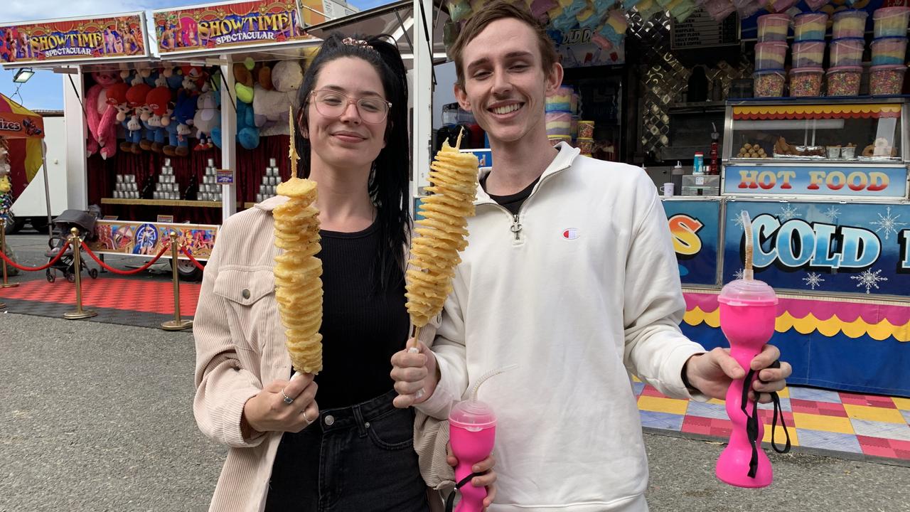 Jas Crawford and Jobi Brien enjoy their twisty potato sticks at the Mackay Show on Thursday, June 16. Picture: Duncan Evans