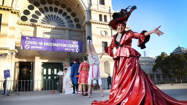 The performers added a splash of colour to the jab hub. Picture: David Caird