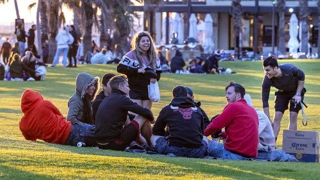 People gather at St Kilda Beach on Sunday, despite strict restrictions. Picture: David Geraghty