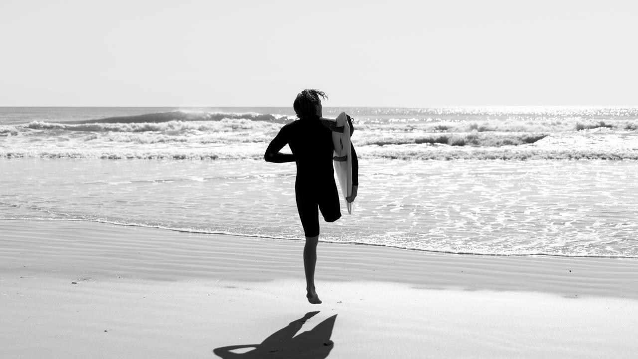 Kai McKenzie heads out for a surf. Picture: Surfing Australia/ Joshua Tabone