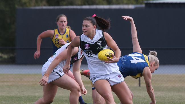 Bond University player Teagan Tatlock (far right, falling) and Southport Player Poppy Boltz (centre). Photo: Mike Batterham.