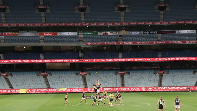 2020: An eerie silence. The first bounce of the 2020 AFL season between Richmond and Carlton takes place in March without a crowd because of coronavirus restrictions. Picture: Michael Klein