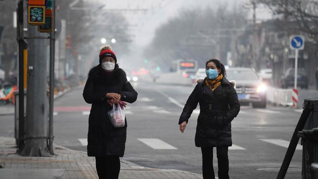 Women on the streets in Beijing in February.