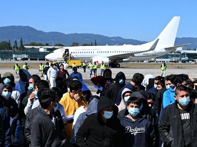 Guatemalan migrants deported from the United States walk down the runway after arriving at the Guatemalan Air Force Base in Guatemala City on January 10, 2025. Guatemala closes 2024 with more than 61,000 deported from the US. (Photo by Johan ORDÃÃEZ / AFP)