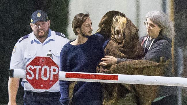 Hannah Quinn is wrapped in a blanket as she leaves Silverwater on Thursday evening with her family after being granted bail. Picture: Damian Shaw