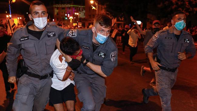 Israeli security officers detain a protester during an anti-government demonstration in front of Prime Minister Benjamin Netanyahu's residence in Jerusalem. Picture: AFP