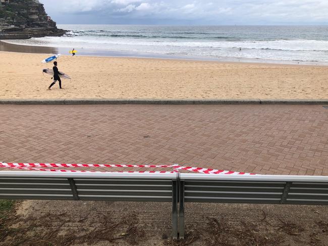 Benches along Manly seafront taped up due to COVID-19 social distancing rules ahead of the long Easter weekend. Picture: Julie Cross