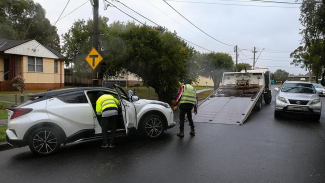 A car at Lansvale is about to be towed after being submerged underwater on Sunday by flooding as the Georges River continues to rise in Sydney. Picture: NCA Newswire / Gaye Gerard