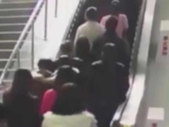 DRAMATIC CCTV footage has emerged of the moment an escalator suddenly changed direction causing a huge human pile up in China