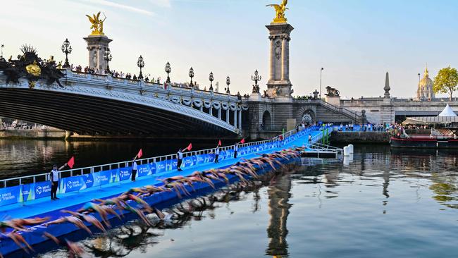 Triathlon athletes compete in a test event on the Seine, which has undergone a cleanup. Picture: AFP