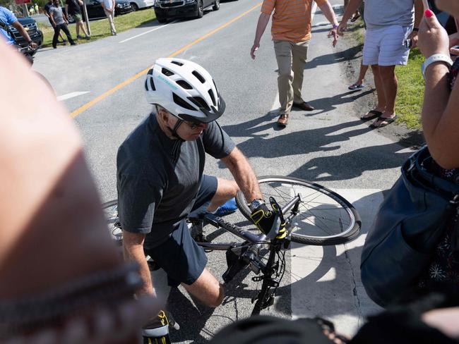 Onlookers rush to Mr Biden’s aid while others film on their phones after he fell off from a bike during a ride in Delaware on June 18, 2022. Picture: Saul Loeb / AFP