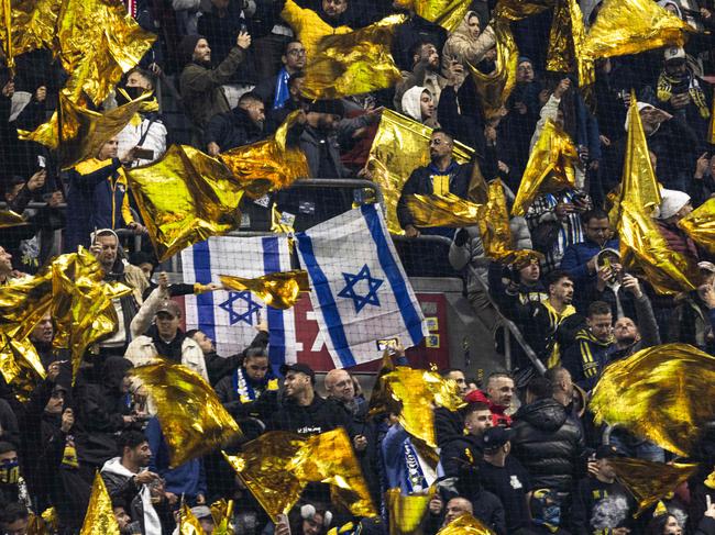 Supporters wave flags during the match between Ajax Amsterdam and Maccabi Tel Aviv on November 7. Picture: AFP