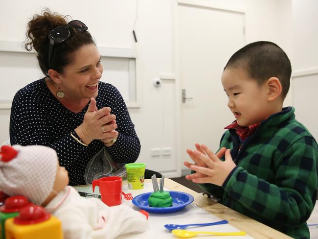 Lead assessor Emma Thomas makes a birthday cake from Playdoh with Charles. Picture: Toby Zerna