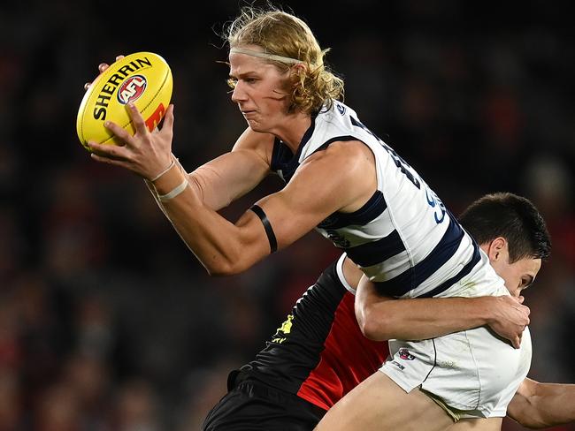 MELBOURNE, AUSTRALIA - MAY 14: Sam De Koning of the Cats is tackled by Cooper Sharman of the Saints during the round nine AFL match between the St Kilda Saints and the Geelong Cats at Marvel Stadium on May 14, 2022 in Melbourne, Australia. (Photo by Quinn Rooney/Getty Images)