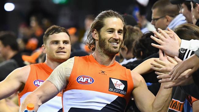 Heath Shaw and Callan Ward high five fans after beating the Western Bulldogs.