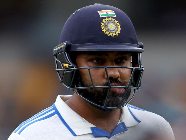 Indiaâs captain Rohit Sharma reacts as he walks off the ground due to bad light on day three of the third cricket Test match between Australia and India at The Gabba in Brisbane on December 16, 2024. (Photo by DAVID GRAY / AFP) / -- IMAGE RESTRICTED TO EDITORIAL USE - STRICTLY NO COMMERCIAL USE --