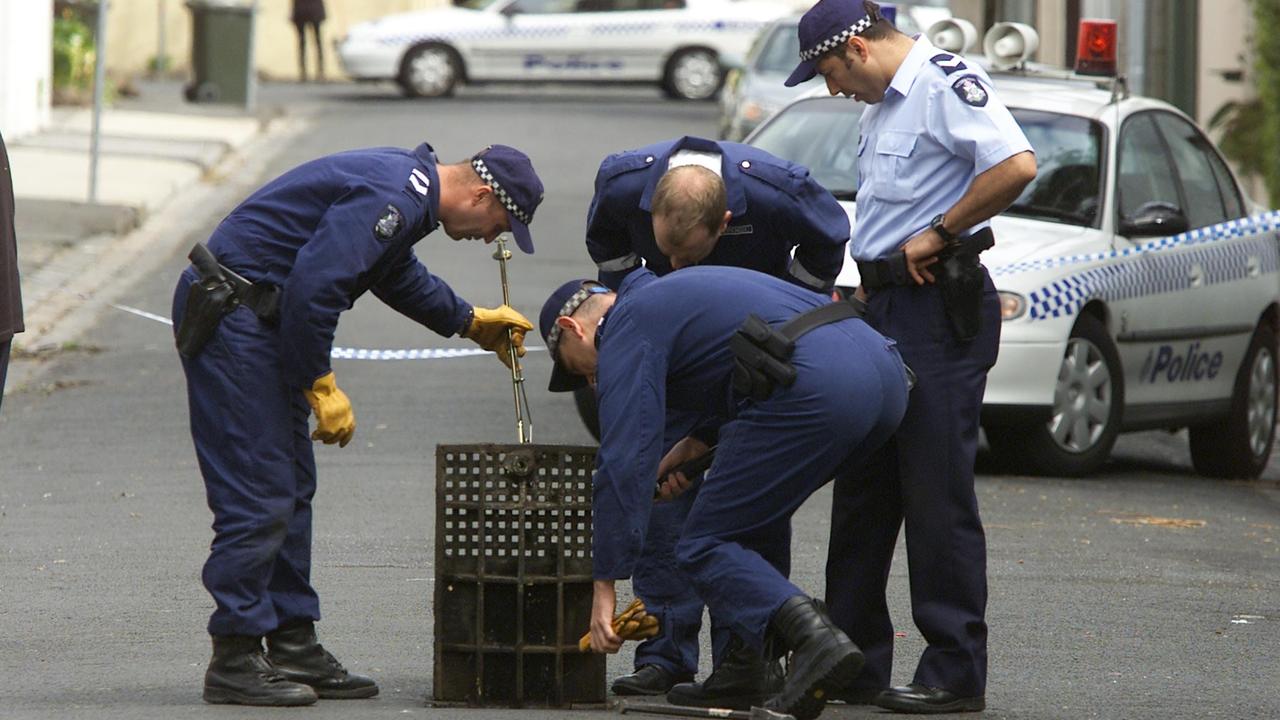 Police look for evidence at the scene of the shooting of Michael Marshall, outside his home in Joy St, South Yarra, Melbourne.