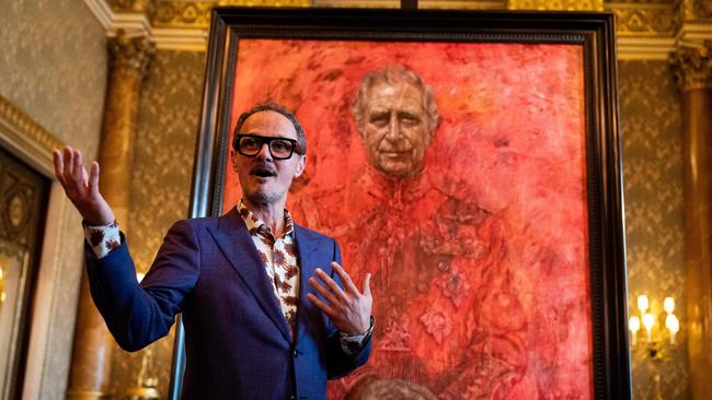 Artist Jonathan Yeo stands in front of his official portrait of Britain's King Charles III wearing the uniform of the Welsh Guards.