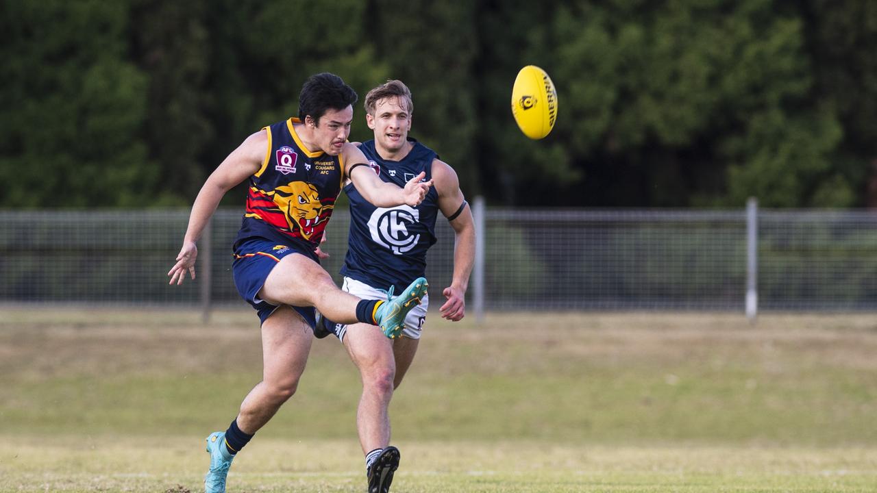 Jaiden Fidge kicks for University Cougars. Picture: Kevin Farmer