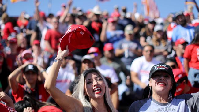 Trump supporters "Latinos for Trump!" during a campaign rally.