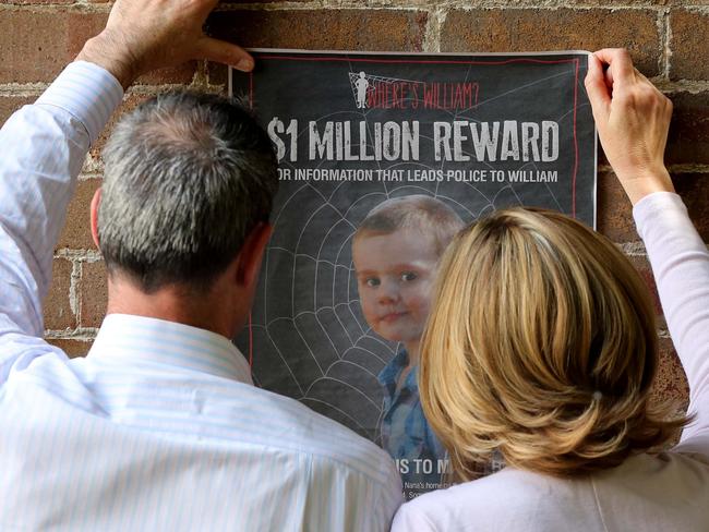 William Tyrrell's foster parents putting posters up in the search for William.