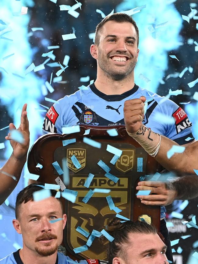 James Tedesco of the Blues holds aloft the Origin trophy after winning the series 2-1 after game three of the 2021 State of Origin Series. Picture: Bradley Kanaris/Getty Images