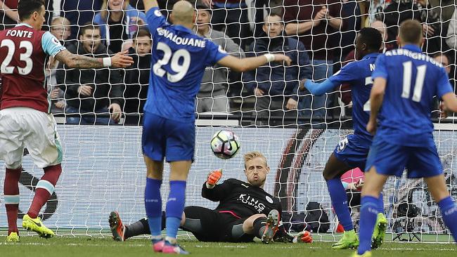 Leicester City goalkeeper Kasper Schmeichel, center, makes a save.