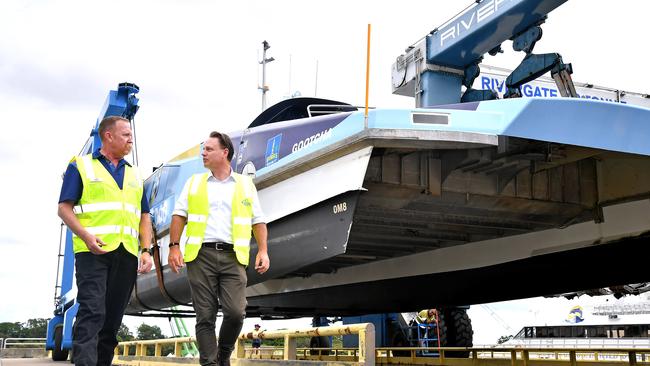 Lord Mayor Adrian Schrinner (right) with a CityCat being lifted out of the water at Riveregate Marina before the cyclone hit. Picture: John Gass