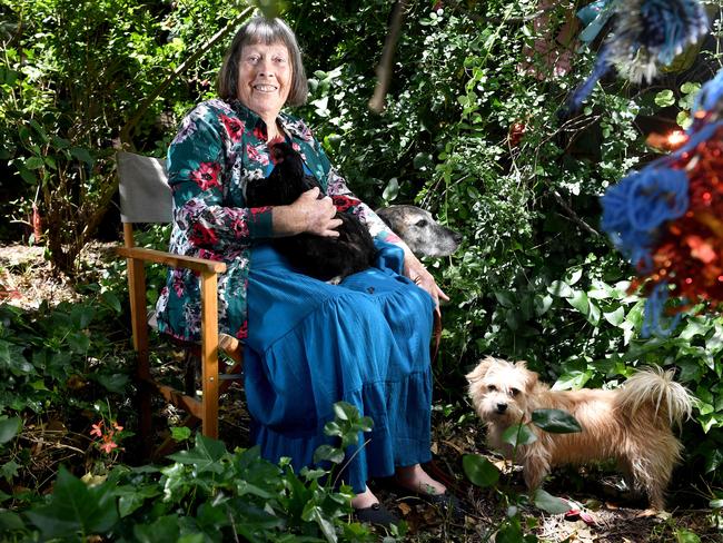 Eighty-year-old Alice Shore, from the Adelaide Hills, keeps busy in her Birdwood garden with pets Feist the hen, and rescue dog Oscar. Picture: Tricia Watkinson