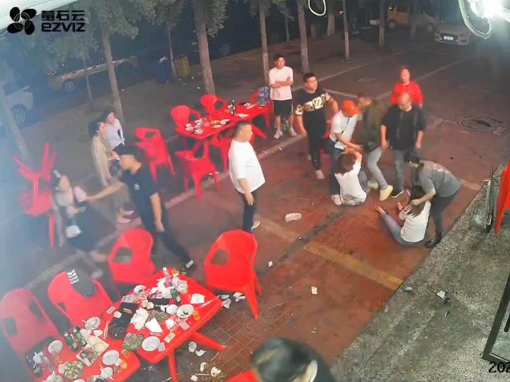 A group of men attack the three women outside the restaurant.