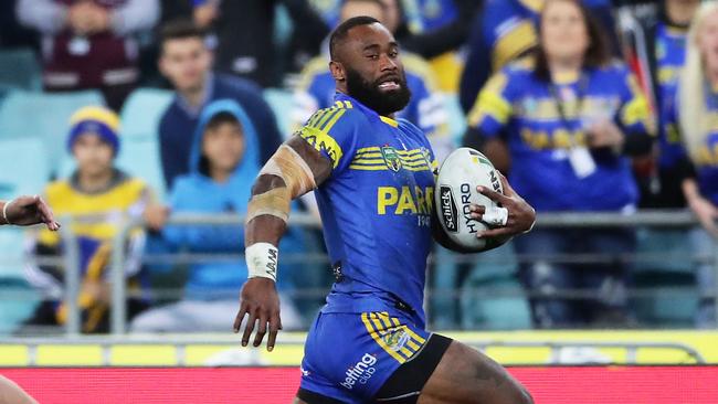 Semi Radradra of the Eels gets past Ashley Taylor of the Titans to score a try.