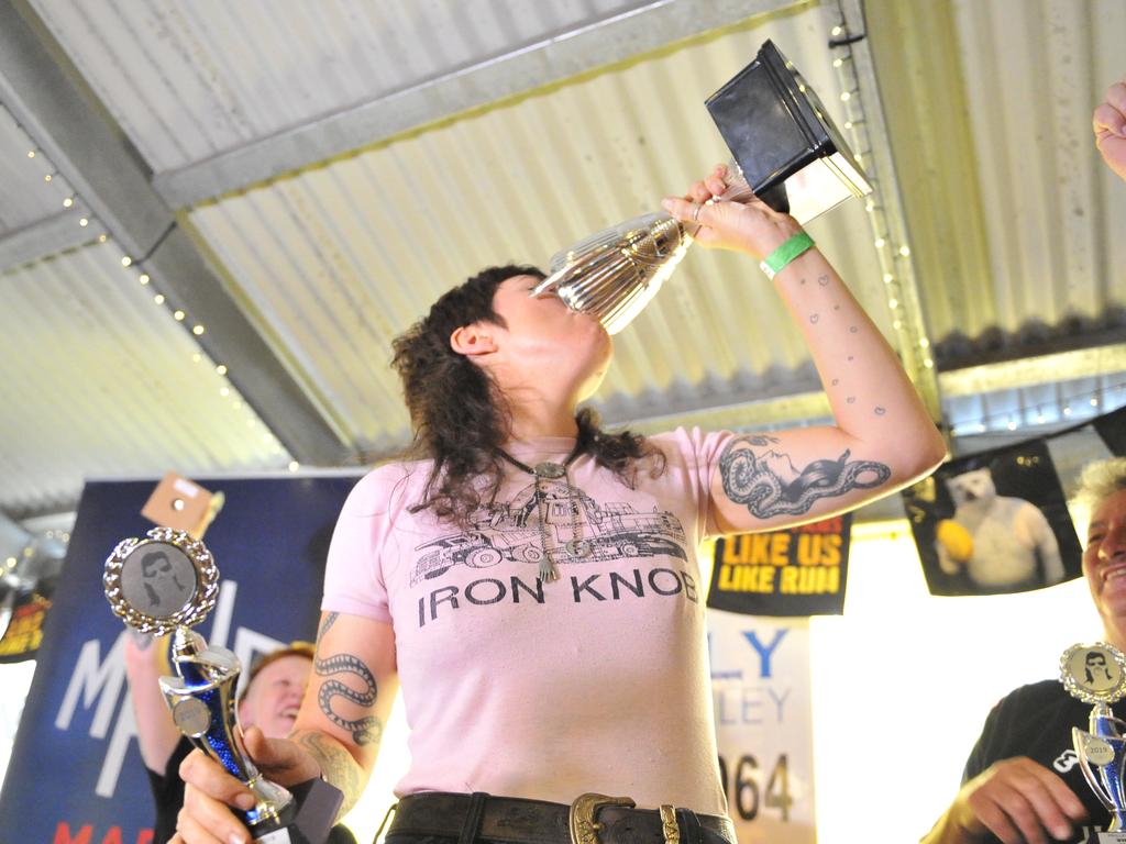 Michelle "Darlzy" Gearin celebrates winning the best mullet competition during Mulletfest, a special event designed to celebrate the hairstyle that's all about business at the front, party at the back, at Chelmsford Hotel in Kurri Kurri, NSW. (AAP Image/Perry Duffin) 