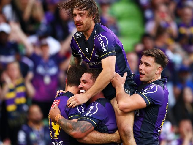 MELBOURNE, AUSTRALIA - MARCH 26:  Nick Meaney of the Storm celebrates with Kenneath Bromwich, Cameron Munster and Trent Loiero of the Storm after scoring a try during the round three NRL match between the Melbourne Storm and the Parramatta Eels at AAMI Park, on March 26, 2022, in Melbourne, Australia. (Photo by Kelly Defina/Getty Images)