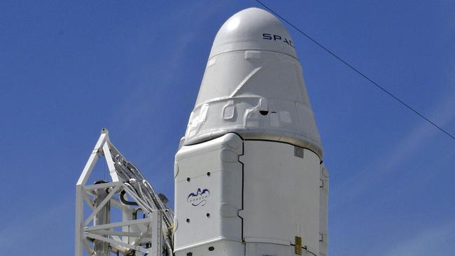 SpaceX's Falcon 9 rocket with the Dragon space craft are readied on October 7, 2012 for an evening launch from Cape Canaveral, Florida, to the International Space Station. This is the first of 12 flights in its 1.6 billion USD contract with NASA to bring supplies to and from the international space station. AFP PHOTO/Bruce Weaver