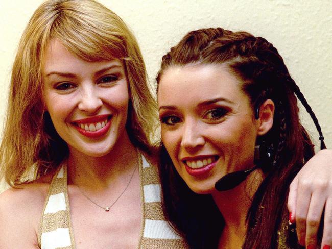 Still close ... Singer Kylie Minogue (L) visits her sister, singer Dannii Minogue, in dressing room at London's Dominion Theatre in 2001. Picture: Supplied.