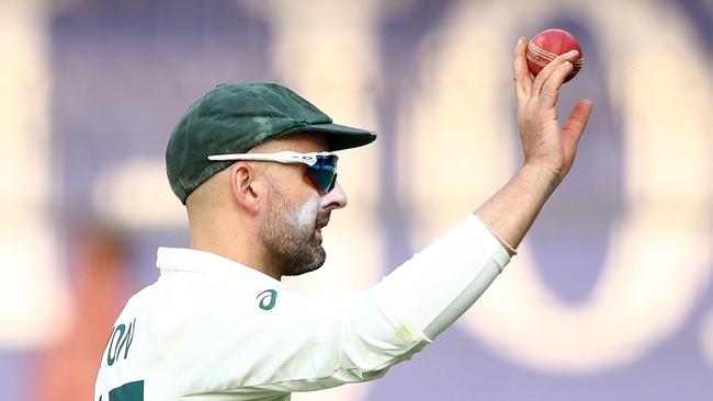 INDORE, INDIA – MARCH 02: Nathan Lyon of Australia holds up the ball after he took eight wickets in the second innings during day two of the Third Test match in the series between India and Australia at Holkare Cricket Stadium on March 02, 2023 in Indore, India. (Photo by Robert Cianflone/Getty Images)