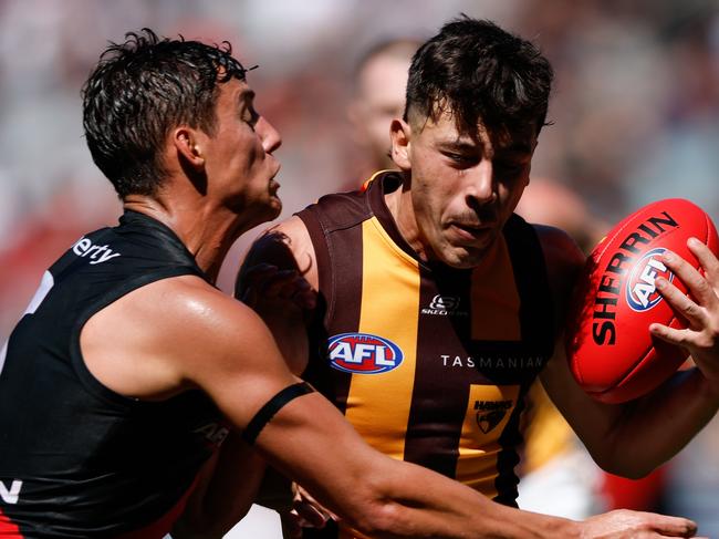 MELBOURNE, AUSTRALIA - MARCH 16: Massimo D'Ambrosio of the Hawks is tackled by Jye Caldwell of the Bombers during the 2024 AFL Round 01 match between the Essendon Bombers and the Hawthorn Hawks at the Melbourne Cricket Ground on March 16, 2024 in Melbourne, Australia. (Photo by Dylan Burns/AFL Photos via Getty Images)