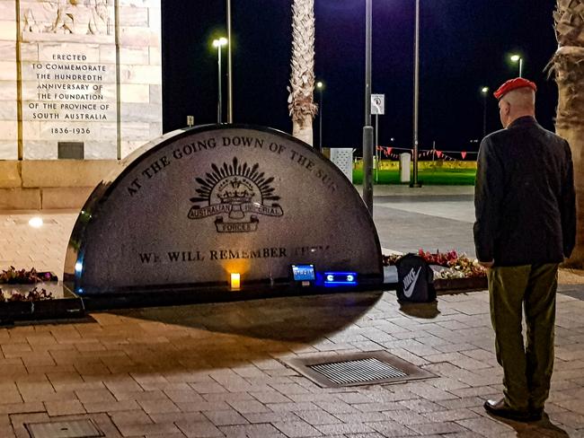 .30 am at Moseley Square, Glenelg, a lone soldier set up his ipad with speakers while he stood following the Canberra Dawn Service on live TV. Picture: Steve Williams