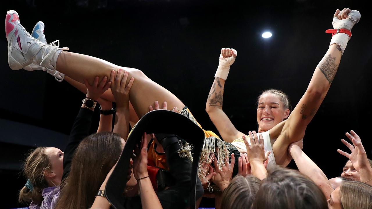 Tayla Harris lifted up by her teammates. Photo by Kelly Defina/Getty Images.