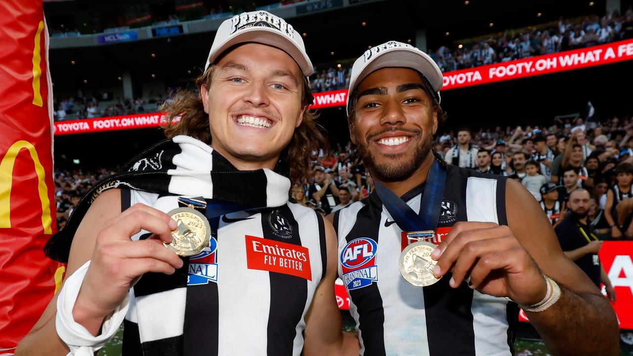 Ginnivan and good mate Isaac Quaynor enjoy their premiership success. Picture: Dylan Burns/AFL Photos