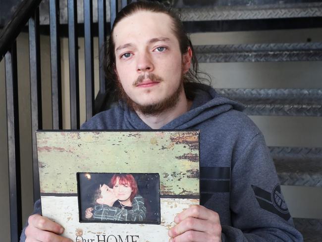 Harley Hayes holds a picture of himself when he was younger and his mother Jenny Hayes who has been arrested for the fire that killed a couple and their baby in Point Cook. Friday, December 4, 2020. Picture: David Crosling